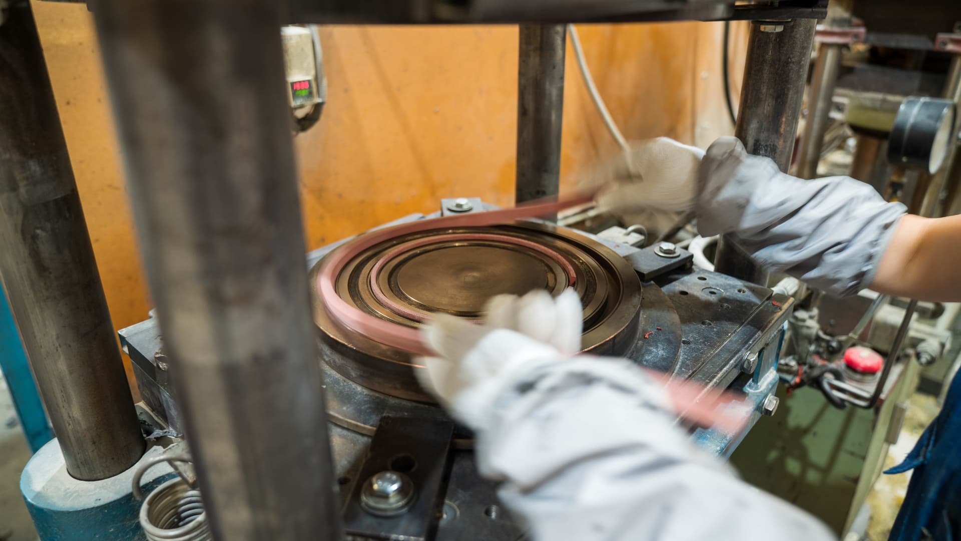 A compression moulding press forming a rubber component at RDL